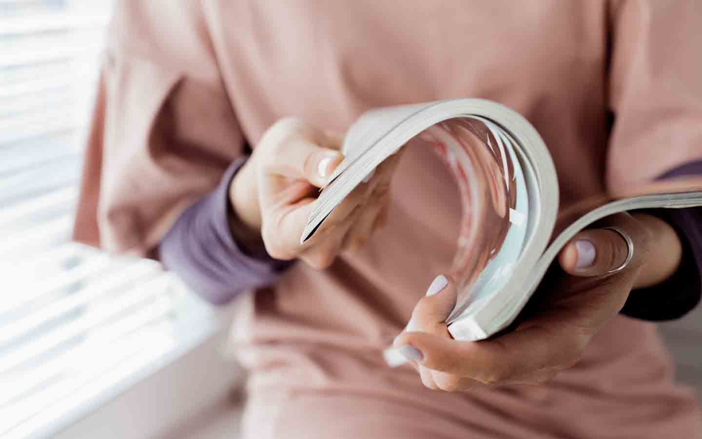 woman looking at magazine design